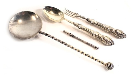 A Victorian silver christening set, comprising spoon and fork, with scroll cast handle, London 1865, silver plated serving spoon, and a swizzle stick stamped sterling, weighable silver 1.43oz.