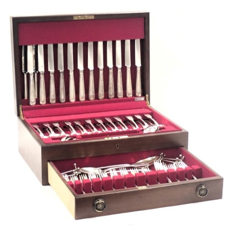 An associated canteen of silver fiddle pattern cutlery, comprising twelve silver handled table knives, two silver handled dessert forks, small ladles, three teaspoons, two tablespoons, one serving spoon, fourteen dessert forks, fifteen table forks, and fo