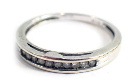 A 9ct white gold half hoop dress ring, set with tension set tiny diamonds, ring size N½, 1.9g all in.