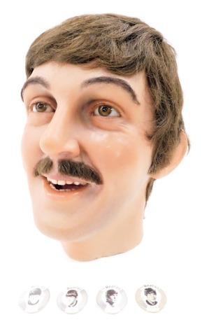 A Paul McCartney wax work head, originally sold by Wilson Peacock Auctioneers, as lot 201 in 2000 ex Madame Tussauds, circa 1942, and a small group of The Beatles pin badges, the head 29cm high.