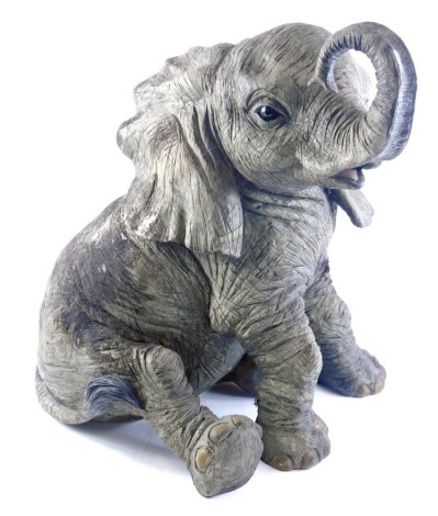 A resin model of a seated elephant, with grey mottled finish, 54cm high.