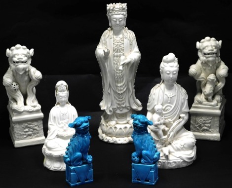 A group of Chinese figures, comprising a pair of blue glazed Dogs of Fo, 13cm high, three figures, 33cm, 22cm and 14cm high, and two moulded Dogs of Fo, on rectangular bases, 22cm high. (7)