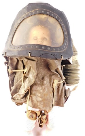 A World War II baby's gas mask, of shaped Perspex cover, with composite doll for demonstration, 43cm high. (AF)