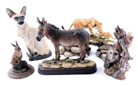 Various animal ornaments, comprising a Country Artists Siamese cat, a Country Artists spring rabbit, a Country Artists lion cubs on rock, a Leonardo Collection donkey, and a barn owl. (5)