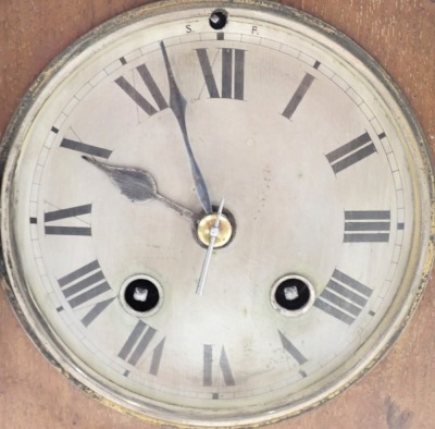 An Edwardian oak mantel clock, with arched top and boxwood tulip inlay and silvered dial, on columned supports with bun feet, thirty hour movement, 25cm high, 26cm wide. (AF) - 2