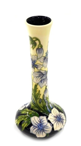 A Moorcroft ceramic bottle shaped vase, decorated with white and pink flowers, impressed marks to underside and handwritten Trial, 21cm high.