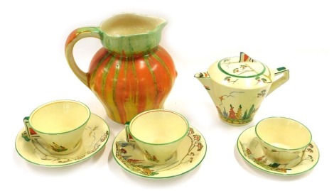 A Norman pottery Art Deco part tea service, decorated overall with cottages, flowers, trees, etc., with raised enamels and angular handles, and a Wade Heath jug with dripped glaze.