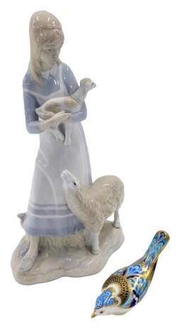 A Spanish porcelain figure of a lady with a sheep and lamb, and a Royal Crown Derby paperweight mountain blue bird (both AF).