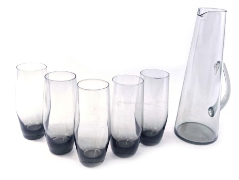 A mid century smoked glass lemonade set, comprising jug, 31cm high, and five beakers, possibly made by Holmegaard and designed by Per Lutkin.