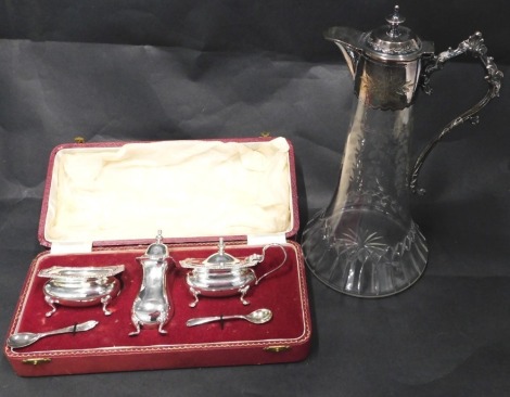 A late 19th/early 20thC cut glass and silver plated claret jug, 29cm high, and a silver plated cruet, boxed.