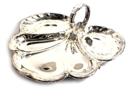 A George V silver hors d'oeuvres dish, with various compartments, cast with scrolls and leaves and with single handle, Sheffield 1915, 15.91oz. (AF)