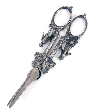 A pair of white metal grape scissors, with berry and vine detail and male and female figures to handles, white metal unmarked, 1.93oz.