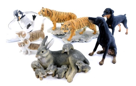 A group of animal ornaments, comprising a H Emblem Whoops penguin figure, dachshunds, Sheraton and Simpson standing kittens, and lions on prowl, unmarked. (1 tray)