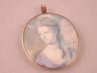 An 18thC portrait miniature of a lady wearing a blue dress and head dress