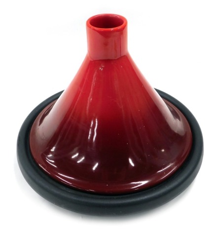 A Le Creuset tagine, with red top and black base, 28cm high.