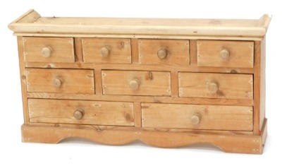 A small pine tabletop chest, of eight drawers, 34cm high, 67cm wide.