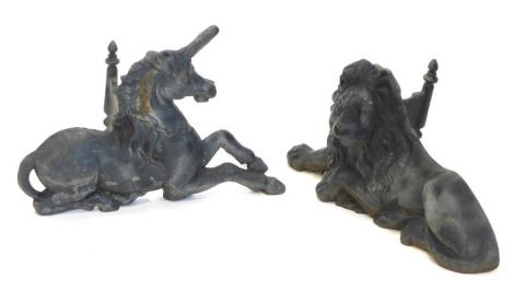 A pair of large cast iron fire dogs, modelled in the form of a recumbent lion and a recumbent unicorn, 57cm wide.