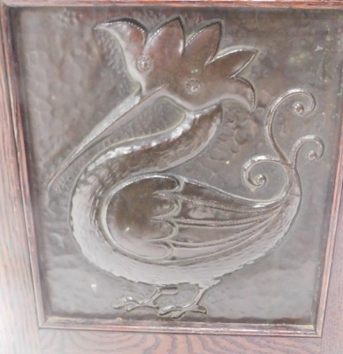 An early 20thC Arts and Crafts oak coal skuttle or box, applied with panels with hammered copper panels each side depicting roundels, squirrel, mythical beast, flower, and a bird, 34cm wide. - 5