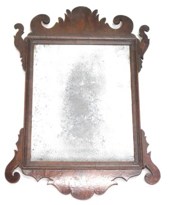 A small mahogany fret framed wall mirror, with distressed rectangular mirror plate, 43cm high, 30cm wide.