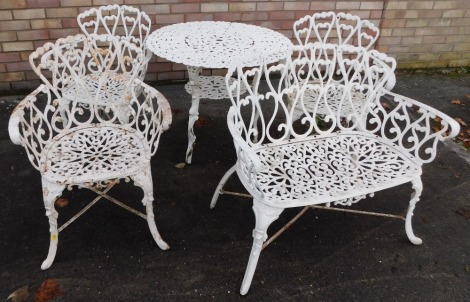 A cream painted cast metal garden table, with pierced decoration, 80cm diameter, matching sofa and three armchairs.