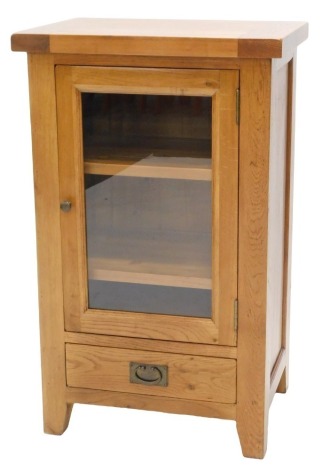 A modern light oak Hi-Fi cabinet, with single glazed door and a drawer, 106cm high, 64cm wide.