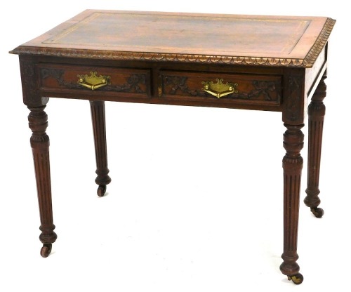 A late 19thC carved oak writing table, with a brown and gilt leather inset, and a leaf carved border, above two frieze drawers, on reeded turned tapering legs and brass and ceramic castors, 72cm high, 92cm wide.