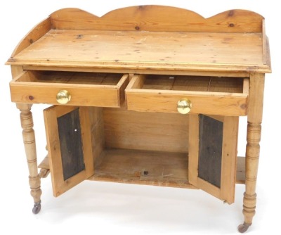 A late Victorian pine washstand, with a raised back above two frieze drawers and two cupboard doors, on turned legs with castors, 106cm wide. - 2