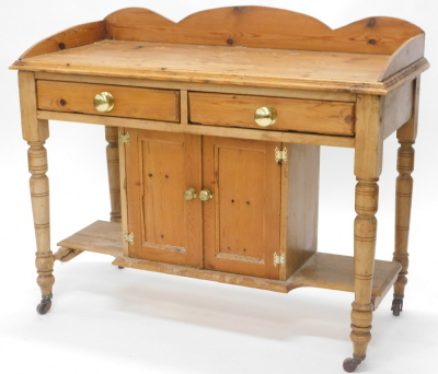 A late Victorian pine washstand, with a raised back above two frieze drawers and two cupboard doors, on turned legs with castors, 106cm wide. - 3