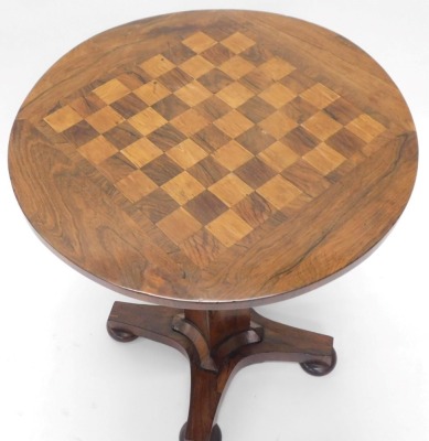 A William IV rosewood games table, the circular top inlaid with a chess board, hinged to reveal recesses for counters, gaming pieces, etc., on a concave tapering column and concave platform with bun feet, 68cm high, 56cm diameter. - 3