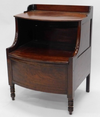 An early 19thC mahogany commode, the top with a hinged lid, with shaped arms and a further hinged section enclosing a recess for a bowl, the panelled bow front on turned legs, 60cm wide. - 2