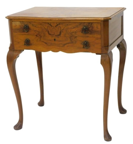 A figured walnut canteen, the serpentine fronted top with a moulded edge, above two drawers with recesses for cutlery, on cabriole legs with pad feet, 69cm wide.