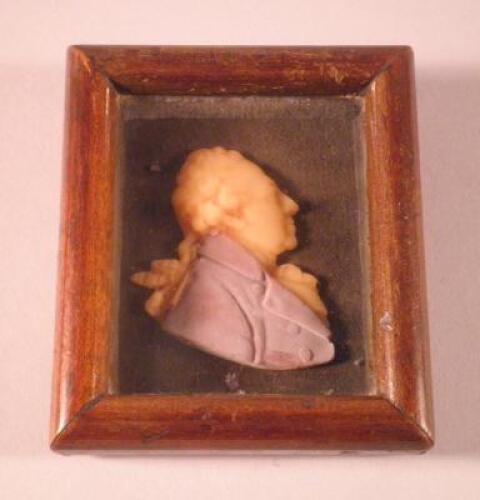 A 19thC coloured wax profile of a gentleman wearing a purple coat