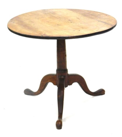 A George III oak occasional table, circular tilt top on a gun barrel turned column and tripod base, 81cm diameter.