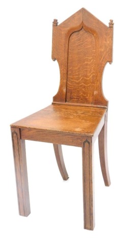 A Victorian oak hall chair, with a solid seat on channelled legs.