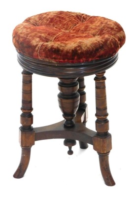 A Victorian walnut adjustable footstool, with a padded seat, on turned supports, with splayed legs, 49cm high.