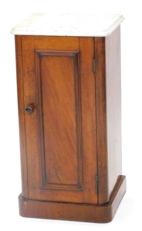 A Victorian mahogany pot cupboard, with a white marble top, above a panelled door, on a plinth, 74cm high, 36cm wide.