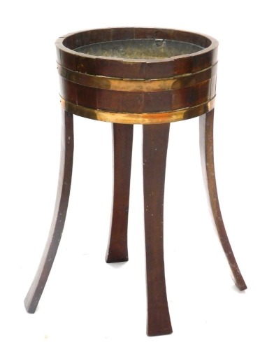 A 19thC mahogany and brass coopered jardiniere or celerette, with splayed legs, 78cm high, 46cm diameter.