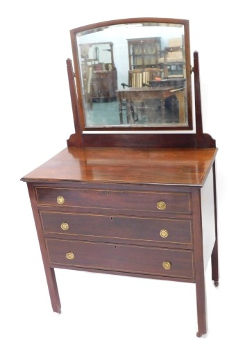 An Edwardian mahogany and boxwood strung dressing table, with rectangular mirror with arched top, above an arrangement of three drawers, on plain legs, 82cm wide.