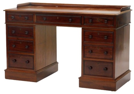 A Victorian mahogany desk, by James Winter and Son of 101 Wardour Street Soho London, the top with a three quarter gallery and a moulded edge, above an arrangement of three frieze drawers and three further drawers to each pedestal, on a plinth, 80cm high,