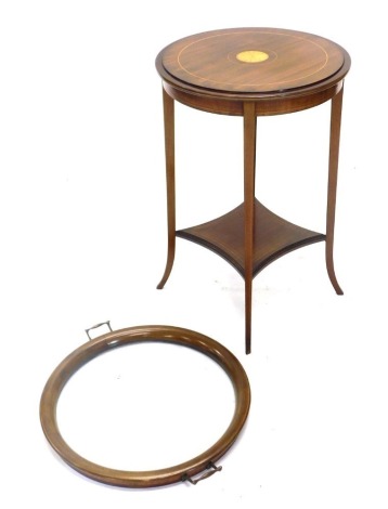 An Edwardian mahogany boxwood strung and satinwood cross banded occasional table, the circular top with a removable glass tray with brass handles, to reveal a solid top with central marquetry patera, on splayed legs with under tier, 76cm high, 56cm wide.