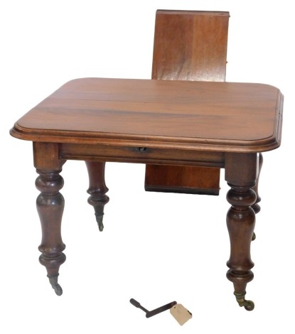 A Victorian mahogany extending dining table, the rectangular top with a moulded edge, on turned supports with brass castors, 72cm high, 100cm wide, 131cm long overall.