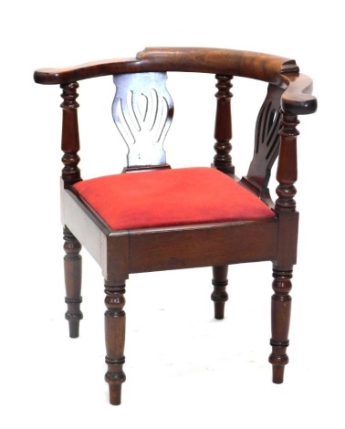 A 19thC walnut corner chair, the back with two pierced splats, a drop in seat, on turned tapering legs.