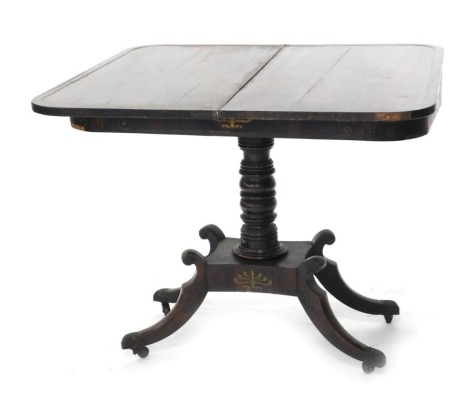 A Regency rosewood and brass inlaid card table, the rectangular top enclosing an interior lacking baize, above a frieze decorated with acanthus and scrolls, on a turned column with shaped platform, splayed legs and brass castors, 94cm wide.