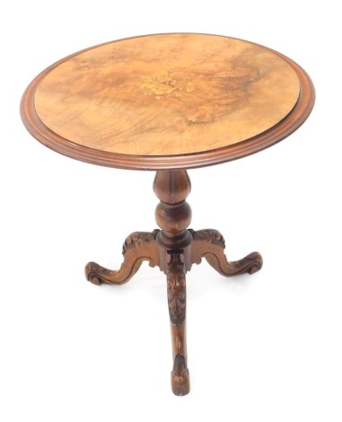 A late 19thC walnut occasional table, the circular top decorated with marquetry, flowers, and a moulded edge, on a turned column and carved tripod base, 54cm high, 52cm wide.