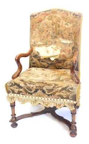 An 18thC walnut open armchair, the back and seat upholstered in associated period tapestry of maidens, putti, etc., on turned legs with X stretcher. (AF)