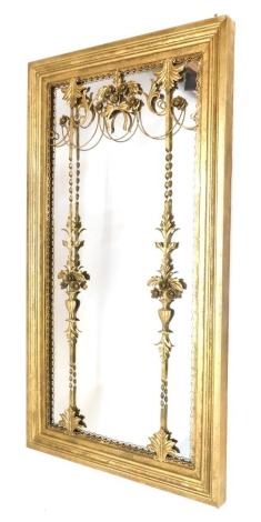 A gilt metal rectangular wall mirror, with applied decoration of scrolls, flowers, urns, etc., 134cm high, 72cm wide.