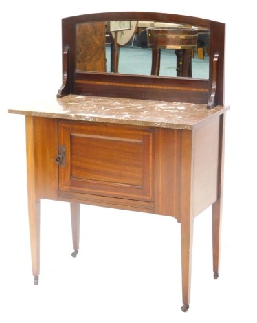 An Edwardian mahogany and satinwood cross banded wash stand, with a raised mirror back, a marble top and a door on square tapering legs, 76cm wide.