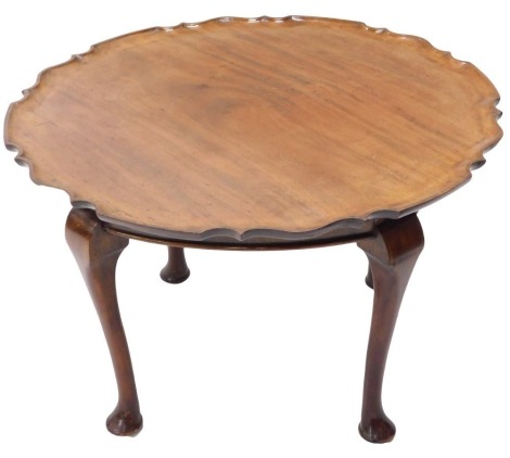 A 19thC mahogany piecrust table top, mounted on a later stand with cabriole legs and pad feet, 48cm high, 74cm wide.