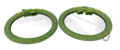 A pair of metal and green bead work oval mirrors, each decorated with flowers, (1 AF), 74cm x 60cm.