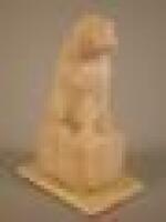 A 19thC ivory carving of a King Charles Spaniel seated on a square pedestal